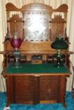 Beautiful antique Victorian walnut organ converted into a slant drop top front desk, with original beveled mirror, candle stands, and fretwork