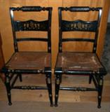 Vintage pair of Hitchcock style painted and stenciled chairs with cane rush seats.