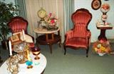View of ladies and gentleman's Victorian chairs, oval coffee table, crystal, marble and brass centerpiece bowl and matching candlesticks with crystal prisms, marble top side table; two Gone With the Wind hand painted lamps, one artist signed