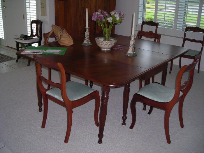 solid wood antique table and carved back chairs