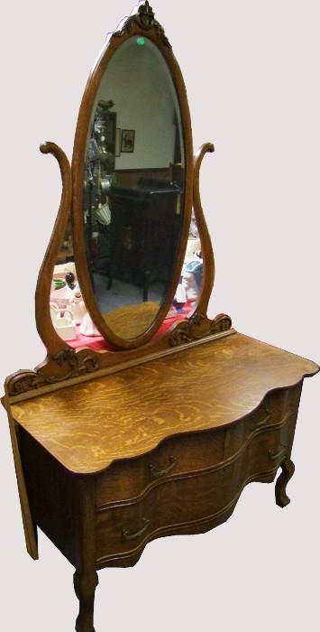 C/1900 Quartered Oak Princess style Lowboy w/oval beveled mirror, carvings and Serpentine front