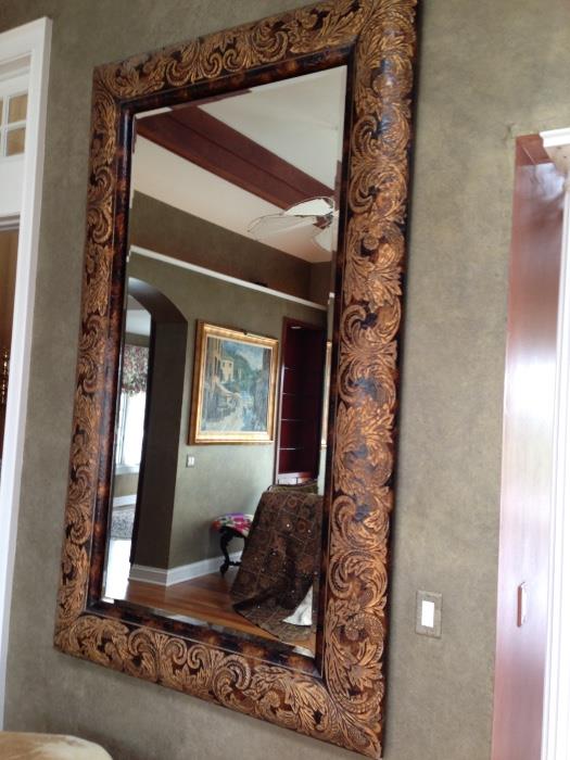 Glass mirror With hand carved wood frame approximately 7 feet tall by 5 feet wide