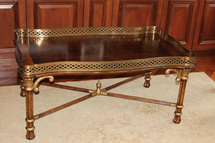 Furniture – Coffee table. Piece is wooden with metal trim and accents. Well made sturdy piece. In excellent condition