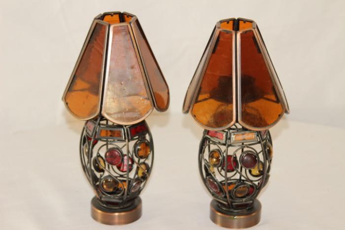 Furnishing – Pair of small table top lamps. Pieces have metal bases with colorful see through stones. Shades are made with amber glass. Pretty pieces. Make a nice set.