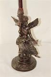 Furnishing – Candle stick holder. Base is an angel holding a small harp and a torch (which is the candle stick). Piece has slight ware to it. 