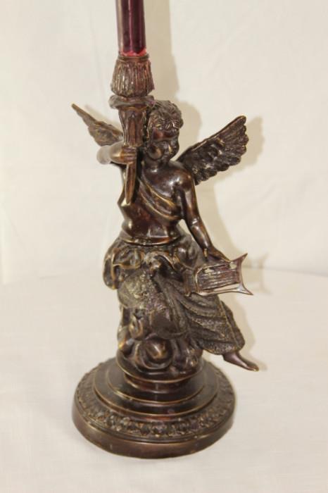 Furnishing – Candle stick holder. Base is an angel holding a small harp and a torch (which is the candle stick). Piece has slight ware to it. 