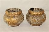 Furnishing – Pair of glass candle holders. Pieces are embellished with golden design. Visible soot marks from candle near top. 