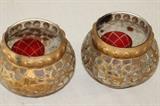 Furnishing – Pair of glass candle holders. Pieces are embellished with golden design. Visible soot marks from candle near top. 