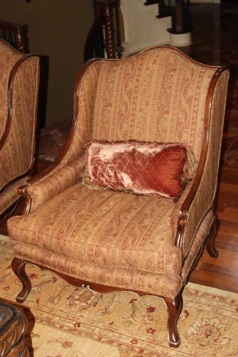 Furniture – Single piece upholstered armchair. Piece has wooden frame and decorative wooden legs. Gilding to wooden trim. Cushioned seats and throw pillow included. The upholstery is maroon and brown patterned. Piece is in very nice condition