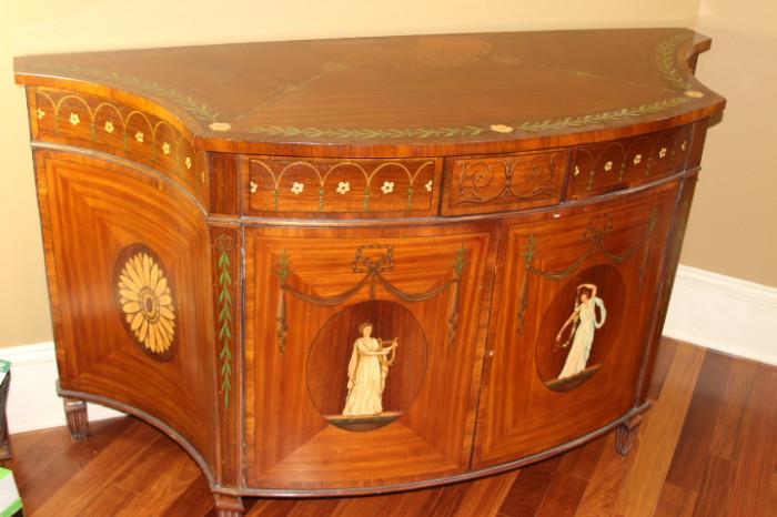 Furniture – Decorative wooden cabinet. Piece is flush to wall. Wood is decorated with leaf and floral pattern. Goddess is painted on each door. Doors open up to reveal three extendible shelves. Unique piece beautifully designed. Mint condition