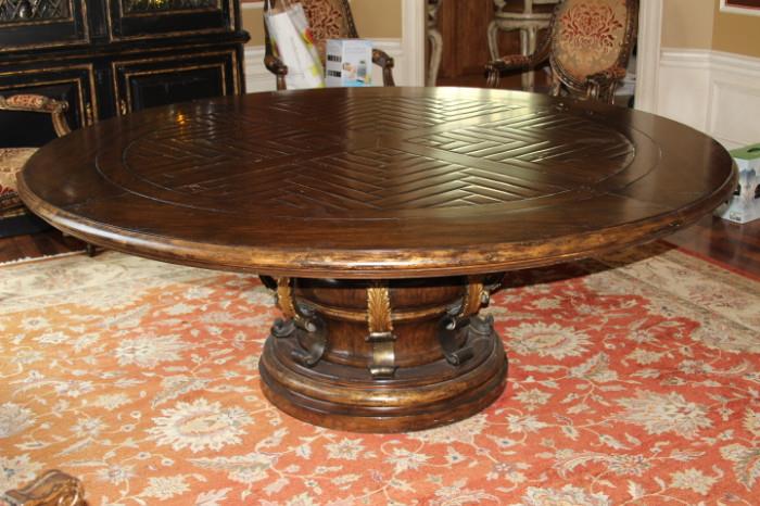 Furniture- Round dining room table. Table sits on one large central foot. Piece has patterned wood on top. Sturdy piece very well made. Unmarked. Near mint condition