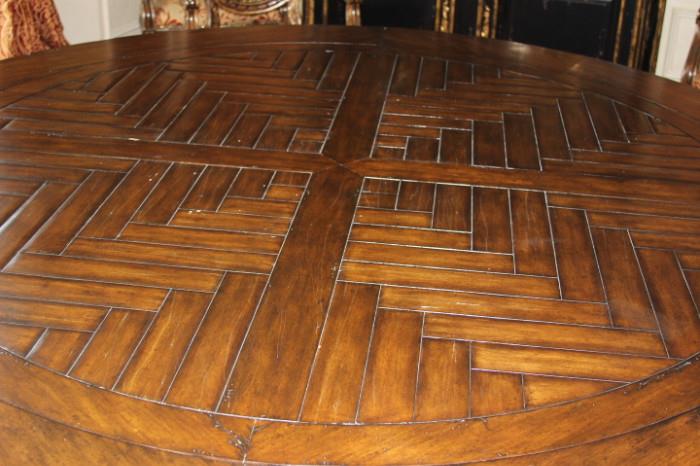 Furniture- Round dining room table. Table sits on one large central foot. Piece has patterned wood on top. Sturdy piece very well made. Unmarked. Near mint condition