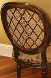 Furniture – Group lot of eight armchairs. Pieces have wooden frame with upholstered seat back and seat cushion. A beige base with red and orange floral pattern. Base and legs are carved. Golden accents throughout. Very nice condition. Piece marked Marge Carson.