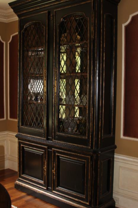 Furniture – Dark wooden china cabinet with cabinet base. Cabinet opens to two shelves. Cabinet has glass doors and opens up to four shelves. Ware to all corners. Bold statement piece