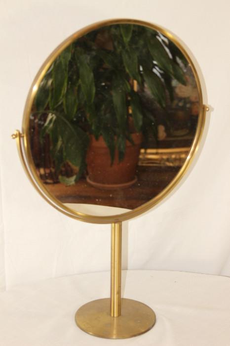 Furnishing – Table top vanity double sided mirror. Piece has a golden base with trim. Mirror is round and it is movable.