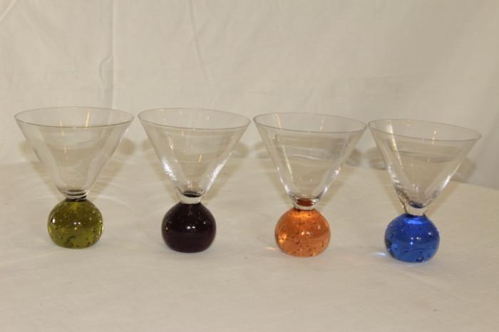 Kitchen – Set of four martini glasses. Pieces have round ball bottom. Each glass has a different colored base. No chips or scratches