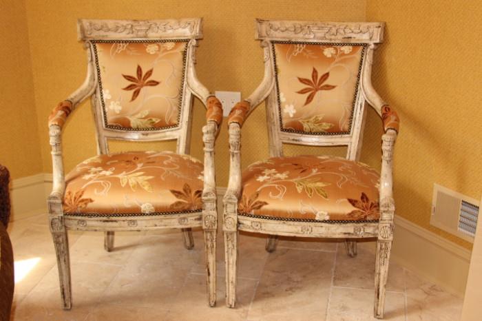 Furniture – Pair of armchairs. Decorative pieces with wooden frame. Seats and backs are upholstered with beige fabric with white and brown embellishments. Sturdy pieces with slight ware to wood. Pieces are in good condition