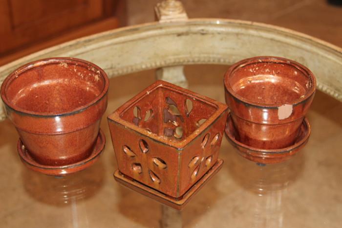 Ceramics – Group lot of three ceramic pieces. Two flower pots and one candle holder. One pot has a visible chip near the top. Unmarked pieces