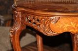 Furniture – Round side table. Piece has decorative legs and lip. Table top is round with different wood coloring making for a lovely piece. Metal trim around half the round table top.