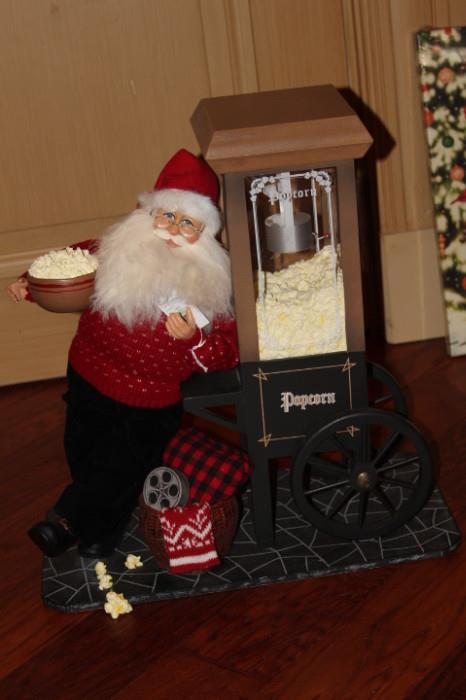 Collectibles – Santa figurine. Piece is beautifully crafted and dressed in black slacks and a red sweater with a traditional Santa hat. Santa is leaning against an air popped popcorn machine. Lovely piece.