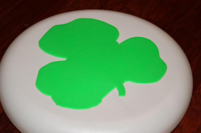 Miscellaneous – Decorative round white piece with a green clover. Inside clover is a watermark of a leprechaun’s face. Pieces can be hung.