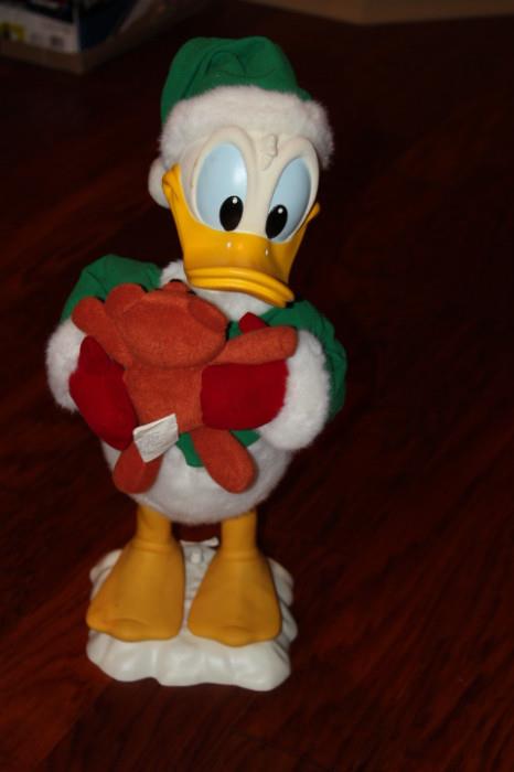 Miscellaneous – Donald Duck standing figurine. Piece is dressed in Christmas garb and it holding a teddy bear.