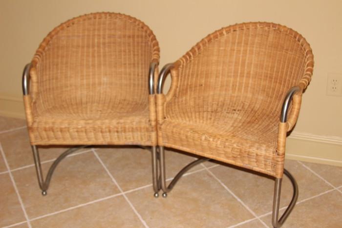 Furnishing – Pair of wicker arm chairs. Pieces have metal frame. In good condition.