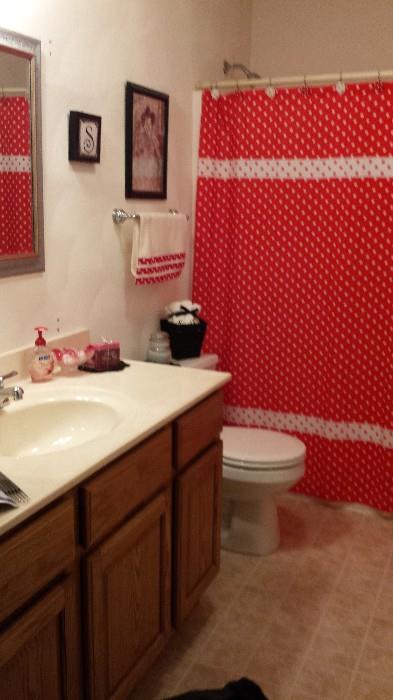Decorative items in bathroom, shower curtain, towels and decor.