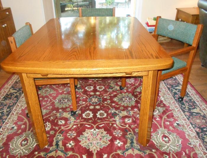 Dining set.  Table is 42" x 58".  Comes with 2 leaves that are 16" wide each.  See handles on end of table,  pull out to insert leaf.