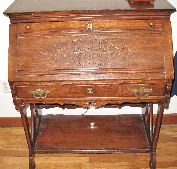 Antique drop desk with carving.