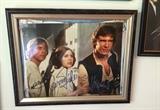 Star Wars Movie Photo Signed by Harrison Ford, Carrie Fisher and Mark Hamill
 