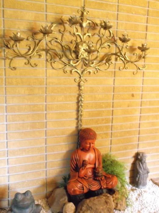 Lighted sconce and oriental statue