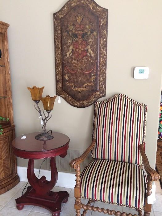 Barley twist striped upholstered armed chair; round top side table; stunning wall panel