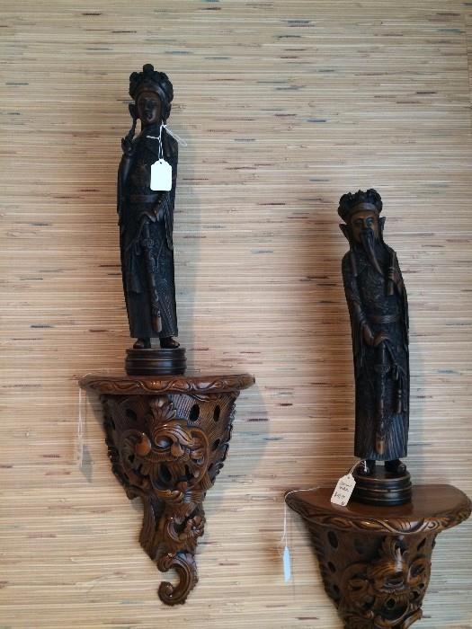 Asian figures on carved wall shelves