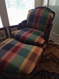 One of two checked upholstered chair with ottoman