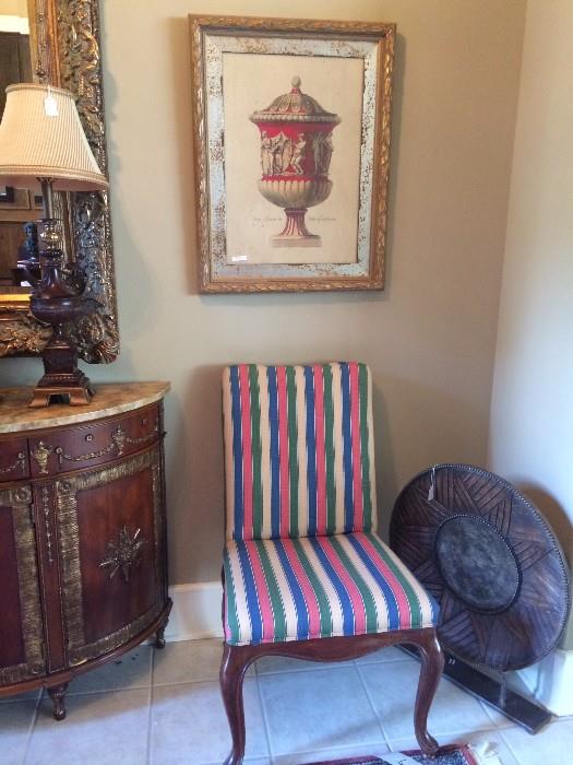 One of two striped chairs; one of two framed urns