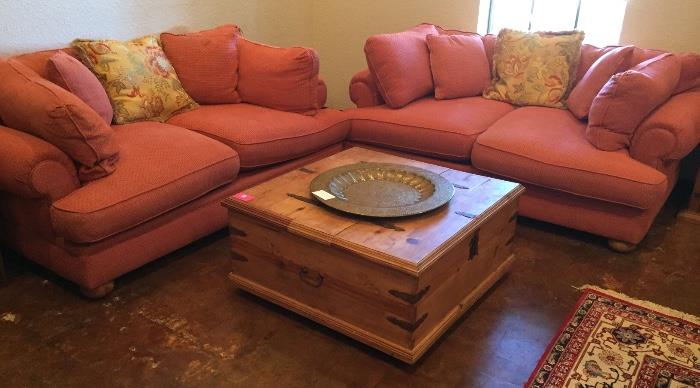 Pair of coral oversized loveseats, pine coffee table chest, and brass tray.