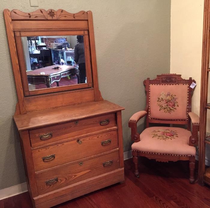 Antique oak dresser with swing mirror and Eastlake needlepoint chair.