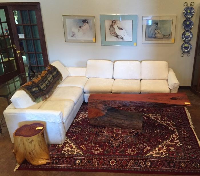Beautiful two piece white sectional sofa, oriental rug, RC Gorman prints, and stump table.