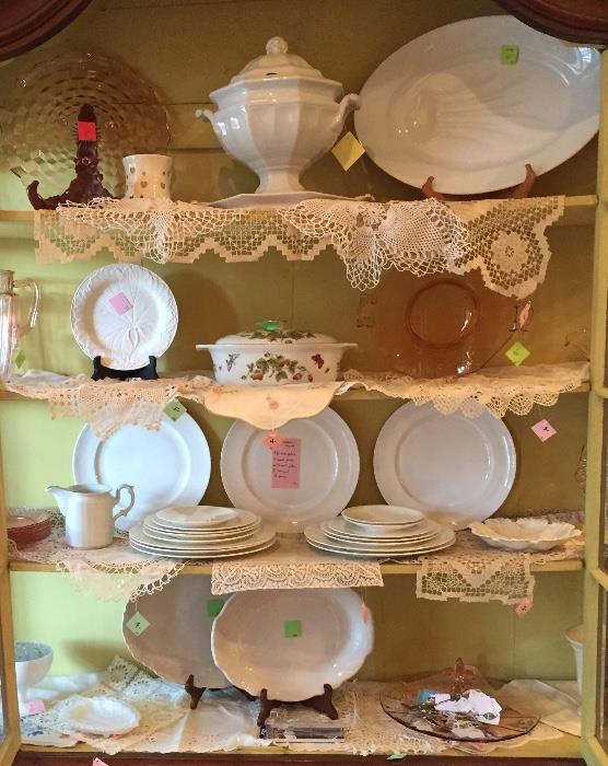 White china, pink Depression glass and vintage crochet pieces.