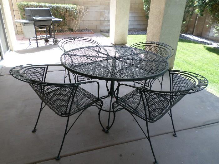Black iron patio table with 4 chairs