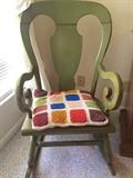 Vintage curved-arm wood rocker with crocheted cushion