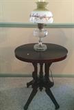 Antique parlor table and another antique glass lamp with painted shade