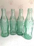 Vintage raised-letter coke bottles (there are two from Huntsville, one from Moultrie, GA, and one from Pulaski, TN)