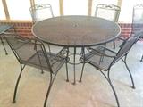 Vintage wrought-iron cafe table with arm-chair seating