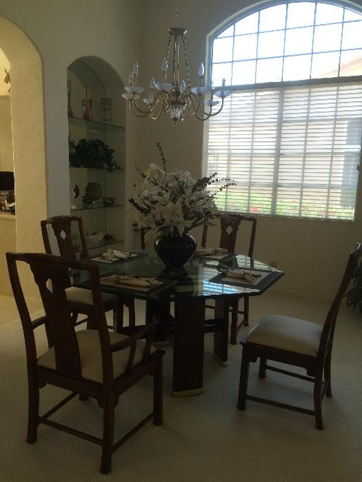 Glass top octagon table with four chairs.
