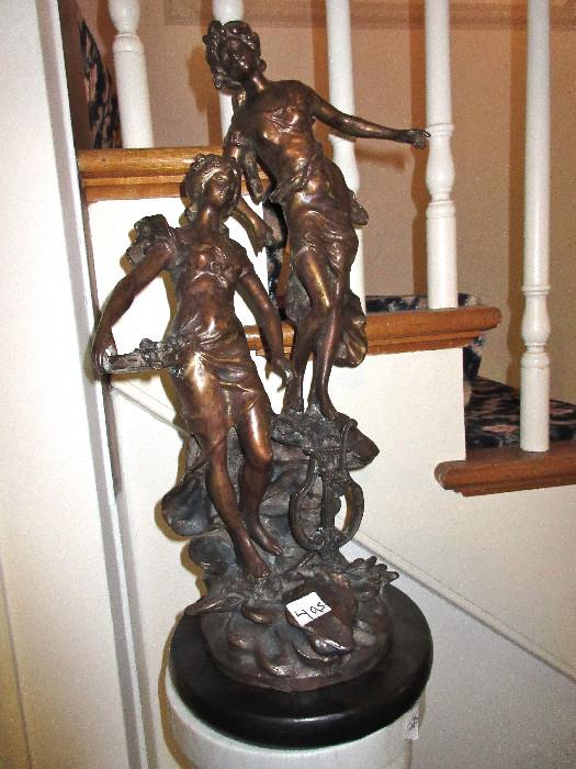 beautiful bronze statue  on a marble pedestal