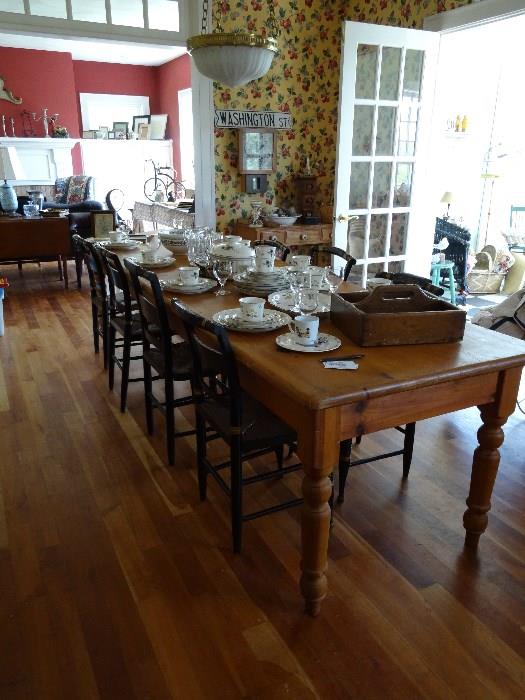 Reproduction 8ft pine harvest table. Hitchcock style chairs from the late 19th century 