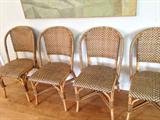 set of four rattan chairs, black and tan, tiki chairs