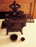 Small Vintage Crescent Miniature Cast Iron Stove with several accessories.